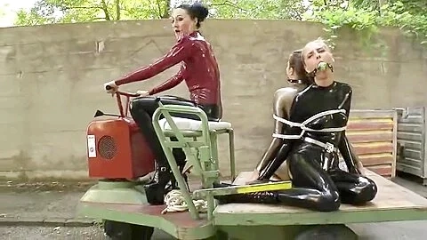 Two Latex Girls Bound And Gagged Outdoors